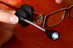 The Eyeglass Light attaches to nearly any eyeglass or safety glass frame and weighs only .7 ounces
